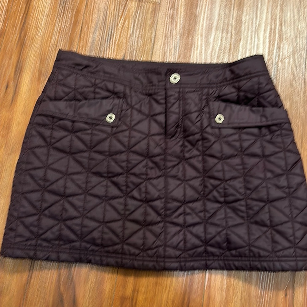 The North Face purple quilted mini skirt. Like new condition.